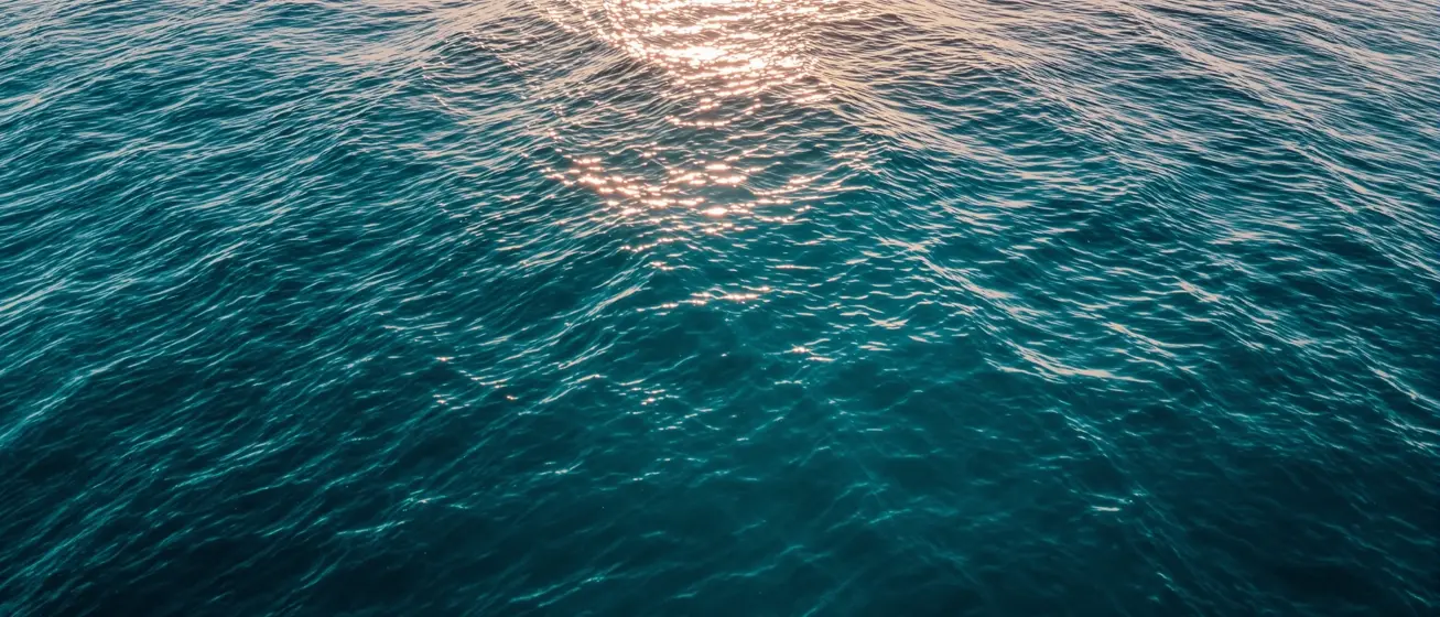 Calm teal ocean at sunrise representing a fresh start with GLP-1 therapy through Open Water Rx