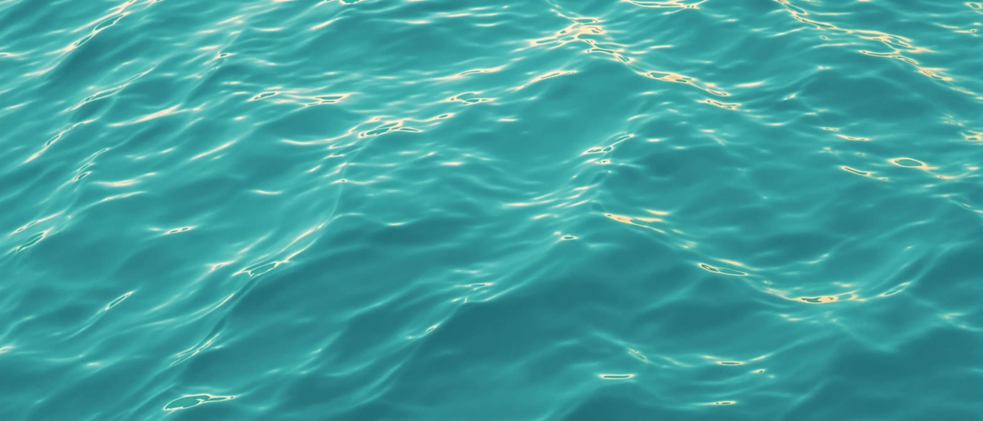 Calm teal ocean water with gentle ripples — decorative background for GLP-1 savings guide