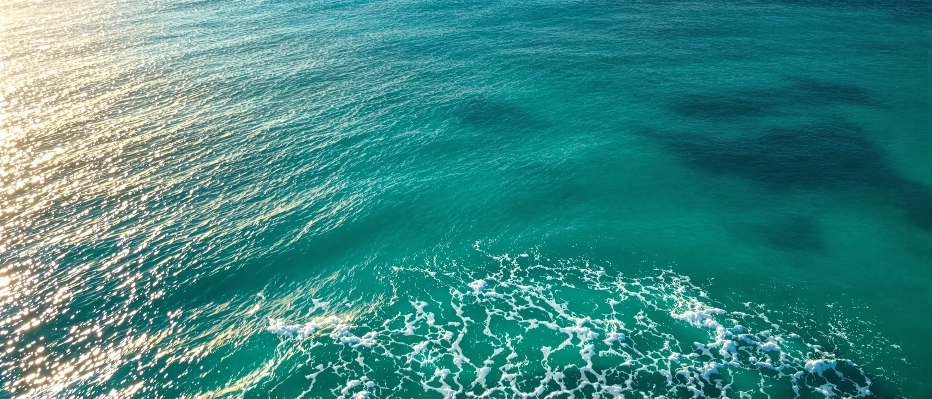 Peaceful aerial view of calm teal ocean water